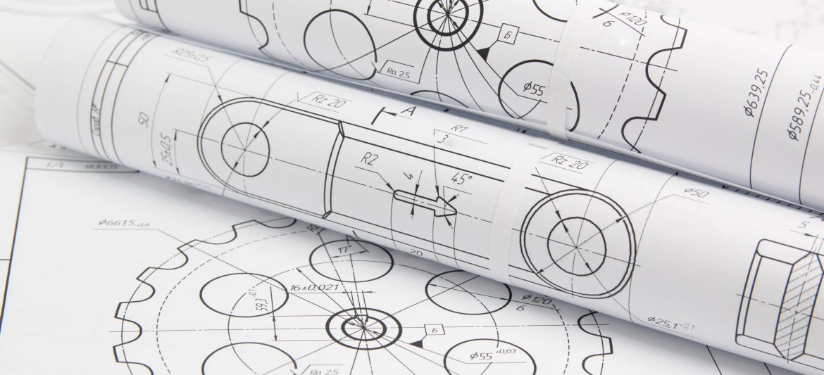 paper engineering drawings of industrial parts and mechanisms